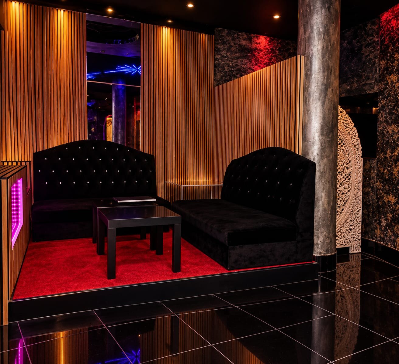 VIP lounge with crystal-tufted sofas and wooden slat walls